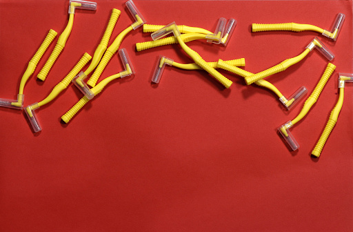.Image of yellow indental brushes on a red background at the top of the frame.