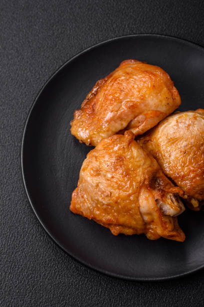 istock Delicious grilled chicken thighs with salt, spices and herbs 1655296427