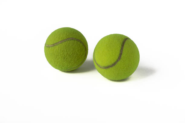 istock Image of two green tennis balls on a white background. 1655299616