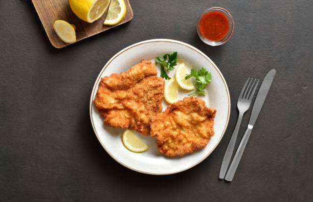 istock Schnitzel with lemon and leaves of parsley 1655318752