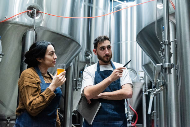 istock Colleagues drinking and working in a beer factory 1655322692