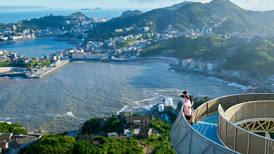A Chinese American couple watches the scenery from an observation deck on the coast of Taizhou, Zhejiang, China