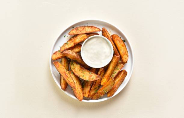 istock Oven baked potato wedges with sauce 1655338700