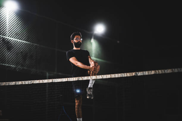 istock Man playing tennis at night 1655353490