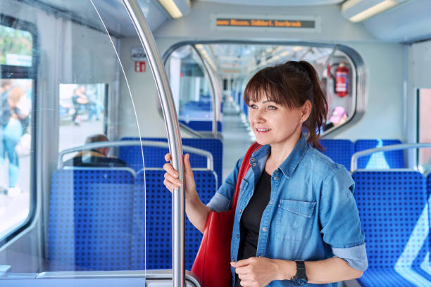 istock Woman is a passenger inside an electric train car 1655415829