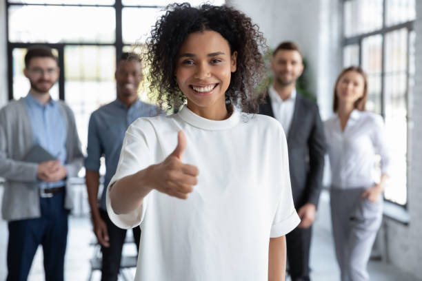 istock Smiling biracial employee show thumb up recommending service 1655471191