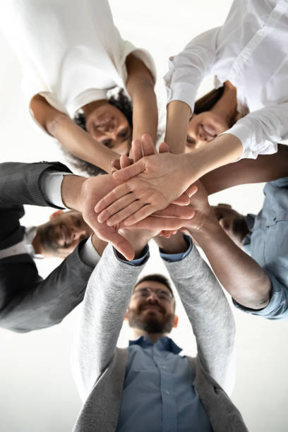 istock View from below of colleagues engaged in teambuilding activity 1655472291