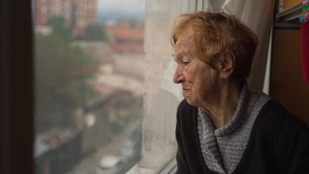 istock old woman looking out window 1655528416