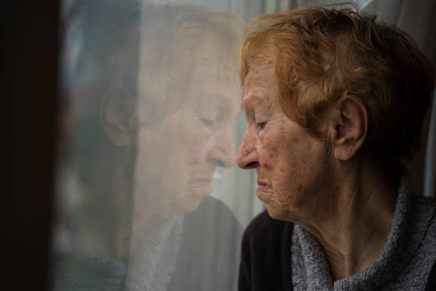 istock old woman looking out window 1655528420