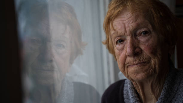 istock old woman looking out window 1655528423