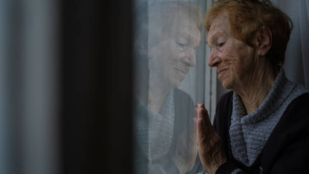 istock old woman looking out window 1655528450