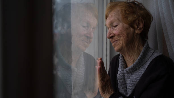 istock old woman looking out window 1655528459