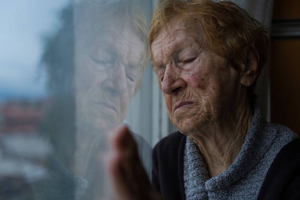 istock old woman looking out window 1655528460