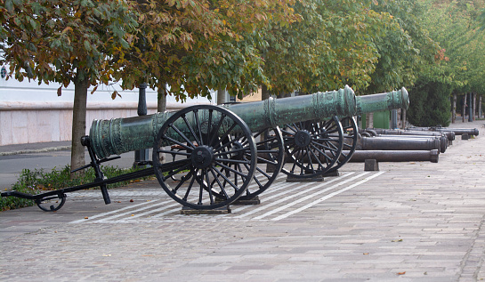 Ancient guns stand on the protection on the walls of the castle. Guns near castle walls