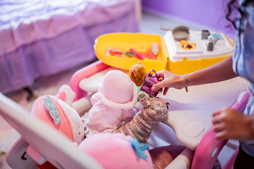Close-up of a child girl playing with toys at home