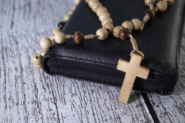 istock Christian wooden crucifix on open bible, point focus. Religious concept image, black and white image 1655653576