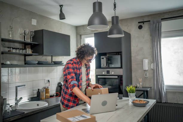 istock one man checking box of received package or product at home 1655657291