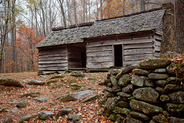 istock Mountain cabin in the fall, with stone wall 165565908