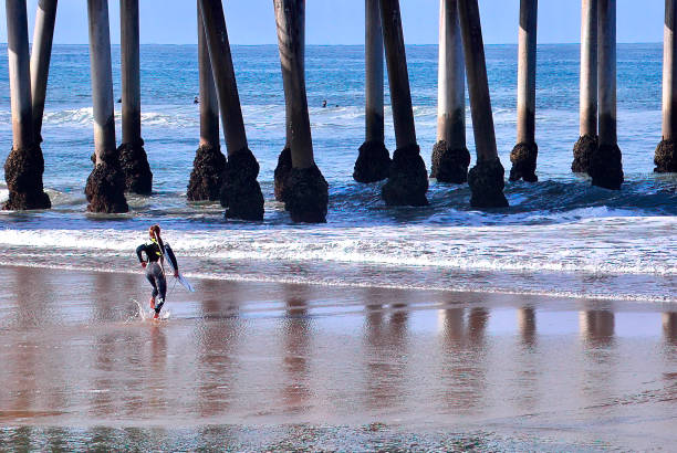 istock Surfer Headed out at Huntington Beach Pier 1655668350