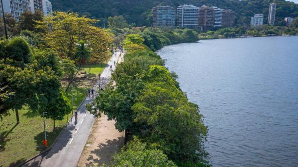 Aerial view of the leisure area and running track at Lagoa Rodrigo de Freitas, where people are jogging and exercising on a beautiful winter's morning in Rio de Janeiro. stock photo