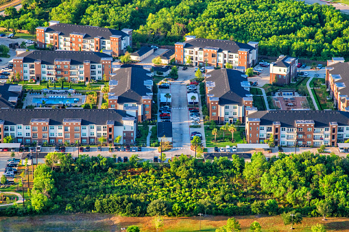 Aerial view of a large multi-story apartment complex located in suburban Houston shot from a helicopter at an altitude of about 600 feet.