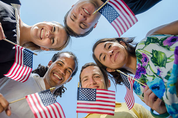 Patriotic Young Adults Smile and Wave Flags
