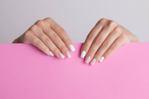istock Female hands with pink and white manicure nails 1655703810