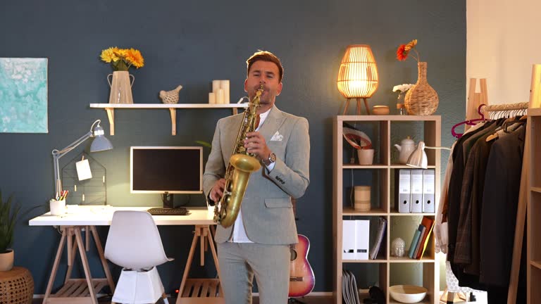 Well-dressed Caucasian male musician, playing saxophone at his home