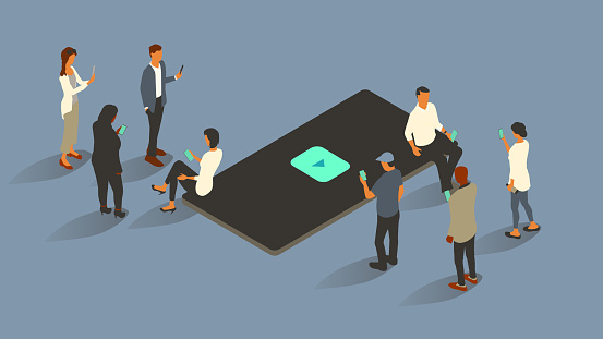 Eight people surround an oversized phone with a streaming video icon on-screen. Everyone uses smartphones themselves. Isometric vector illustration leverages a limited color palette on a 16x9 artboard. Icon created from scratch by the illustrator.