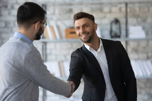 istock Smiling businessmen handshake get acquainted at meeting 1655755854
