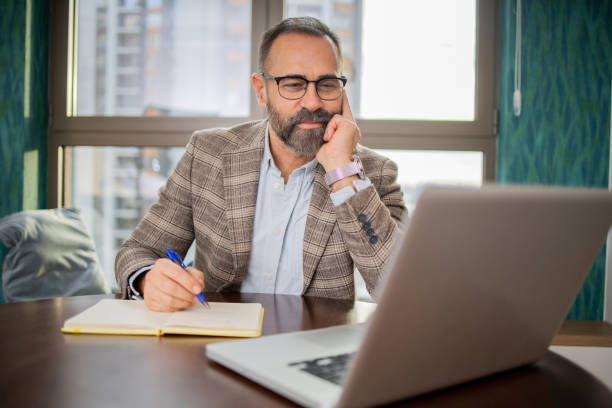 istock Mature fashionable man working at home 1655796890