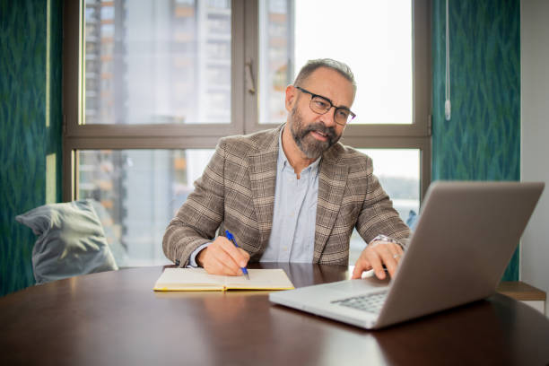 istock Mid adult man working from home 1655797989