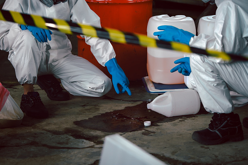 Specialist Officers in Chemical Safety Wear Chemical Risk Protective Clothing, Investigating and Determining The Type of Chemical Spill. Prepare for Chemical Spills Cleanup.