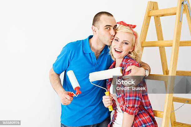Happy Couple Painting A Wall Stock Photo - Download Image Now - 25-29 Years, 30-34 Years, Adult