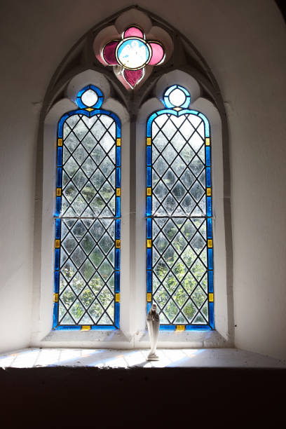 istock Light streaming into church through stained glass window 165581251