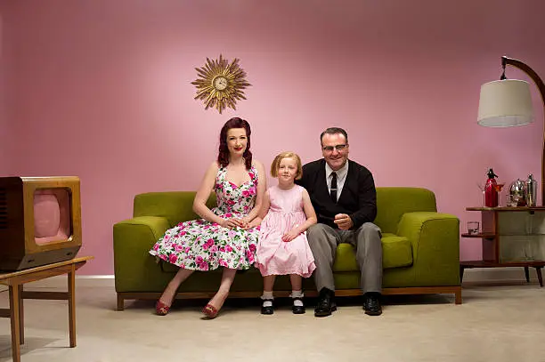 retro family pose for a photo in their lounge