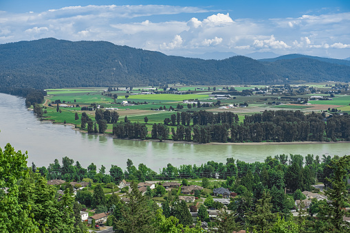 View of the Fraser Valley near Abbotsford BC. Summer in the Fraser Valley. Canadian homestead. Rural agricultural land. The Frazier River is an important salmon habitat for the lower mainland of BC