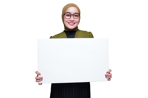 Smiling asian hijab woman holding white board