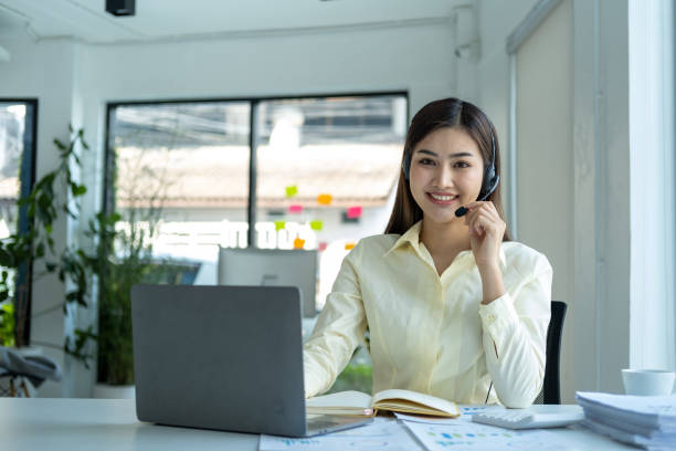 istock Call center, woman and working in team office with headset, computer and online customer support, service or help. Businesswoman, smile and contact us, crm and telemarketing employee talking 1656048094