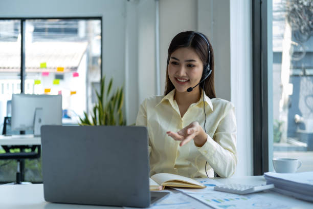 istock Call center, woman and working in team office with headset, computer and online customer support, service or help. Businesswoman, smile and contact us, crm and telemarketing employee talking 1656048096