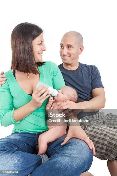 A Young Couple Feeding Their Infant Stock Photo - Download Image Now - 25-29 Years, 30-34 Years, Adult