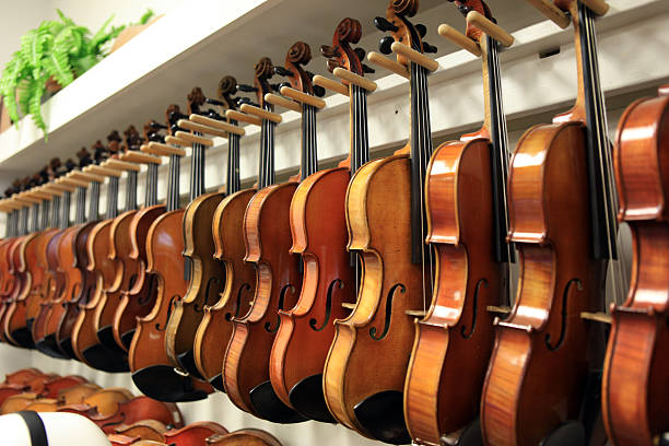 istock Violins Hanging in Music Store 165614878