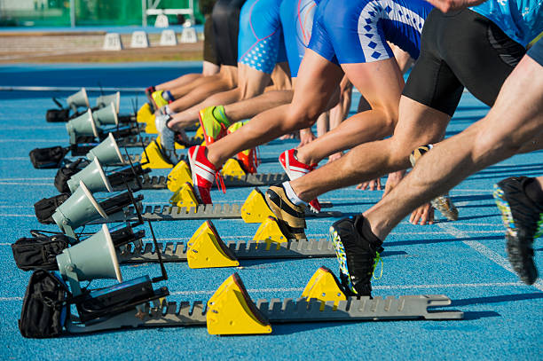 gruppo di otto atleti a partire da 100 m - rivalry starting block track and field athlete track and field foto e immagini stock