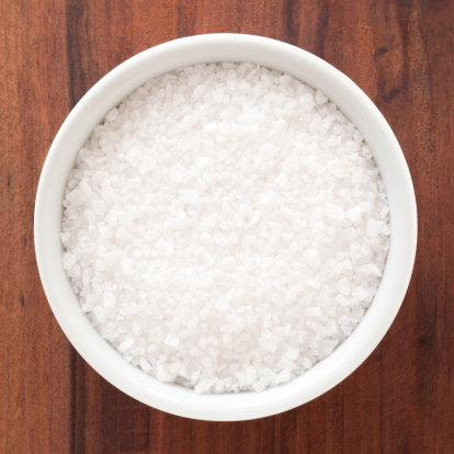 Top view of white bowl full of rock salt