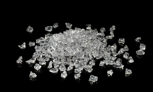 Pile of faux uncut diamonds isolated on a black background. These glass shards look uncannily like rough diamond gems and could easily pass for them. Canon 5D MarkII.