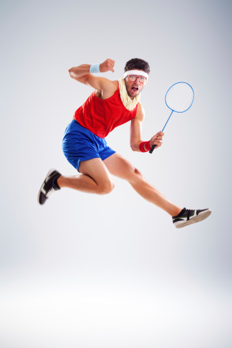 Successful tennis player with glasses jumping