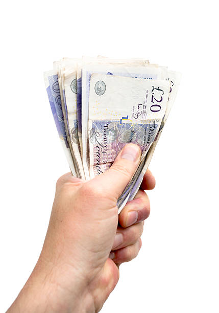 Hand With Money Hand Holding Twenty Pound Notes pound symbol stock pictures, royalty-free photos & images