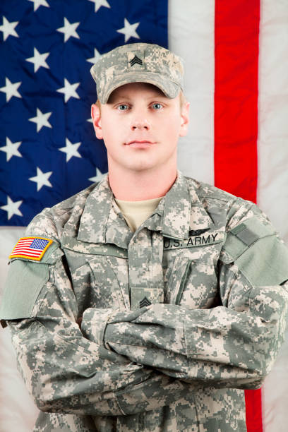 istock American Soldier Series: Young Sergeant Standing against USA Flag 165615717