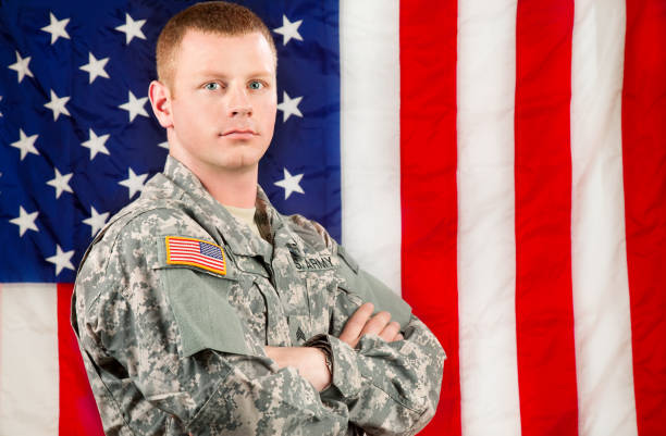 istock American Soldier Series: Young Sergeant Standing against USA Flag 165615721