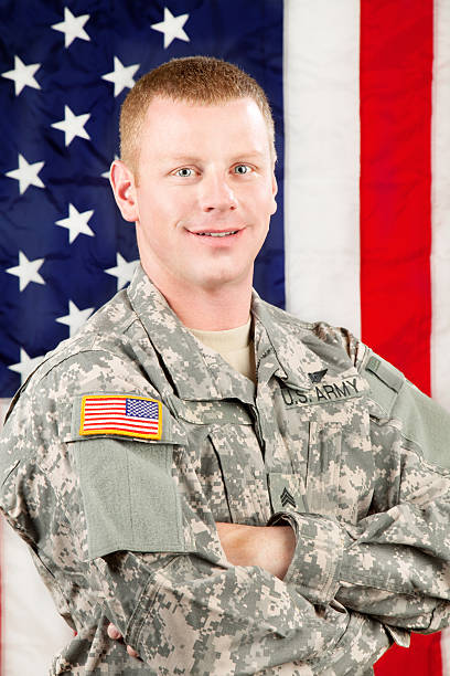 istock American Soldier Series: Young Sergeant Standing against USA Flag 165615726